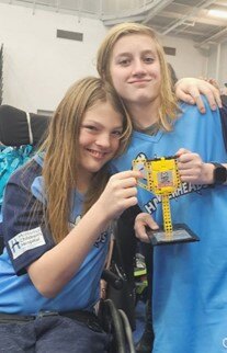 Team Hammerheads participants holding a FIRST LEGO League trophy.