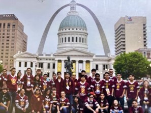 The Gryffingears, an FTC team, stands in front of a state capitol, posing and smiling for a group photo.