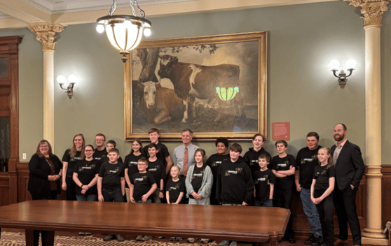 Team Circuit Breakers stands with Wyoming's governor Mark Gordon at the capitol building.