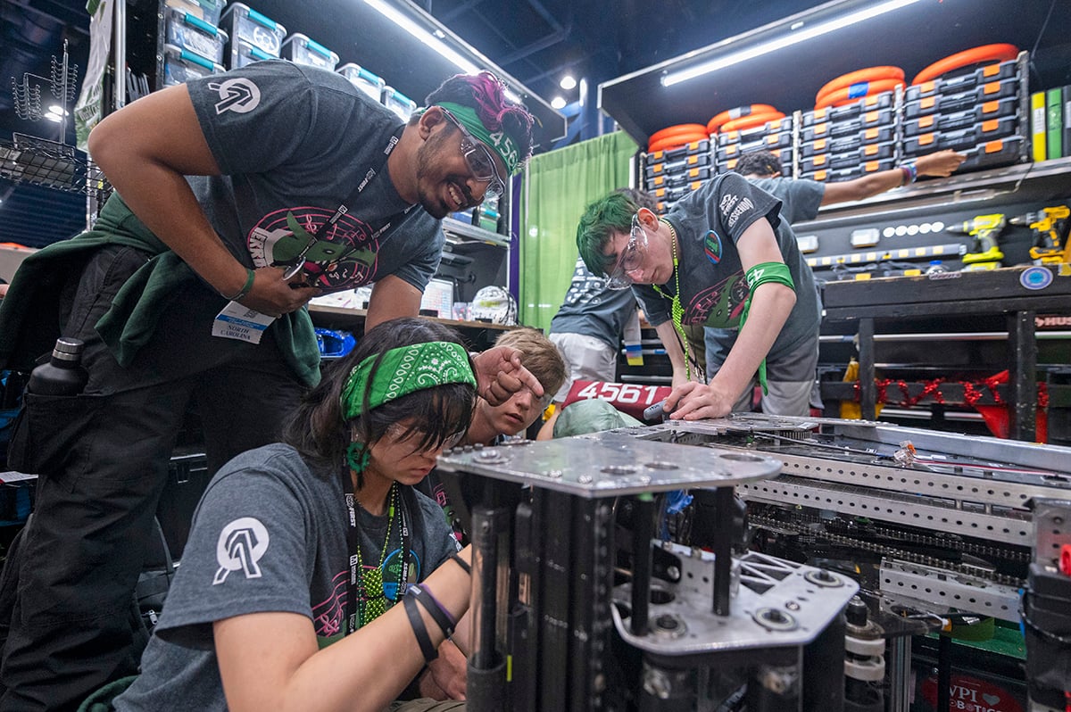 A team working to make repairs to their robot. 