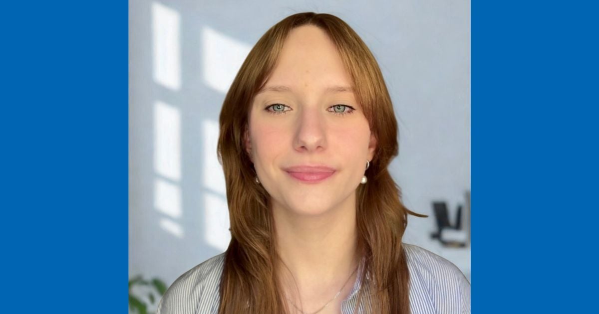 Amanda smiles and poses for a professional headshot.